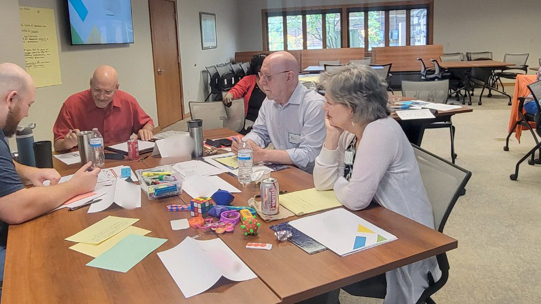 people sitting around a table having a discussion